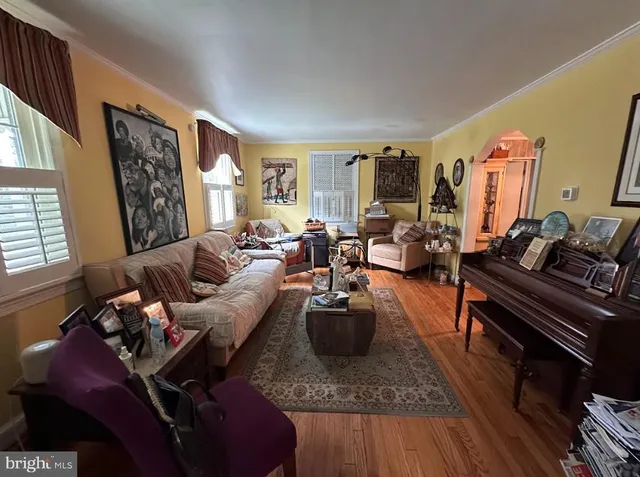 a living room with furniture fireplace and a large window