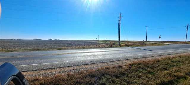 a view of a room with an empty space and wooden floor