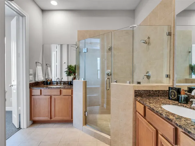 a bathroom with a granite countertop sink a mirror and a bathtub