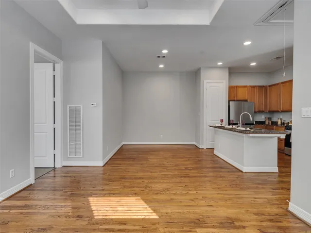 a view of kitchen with kitchen island microwave and view living room