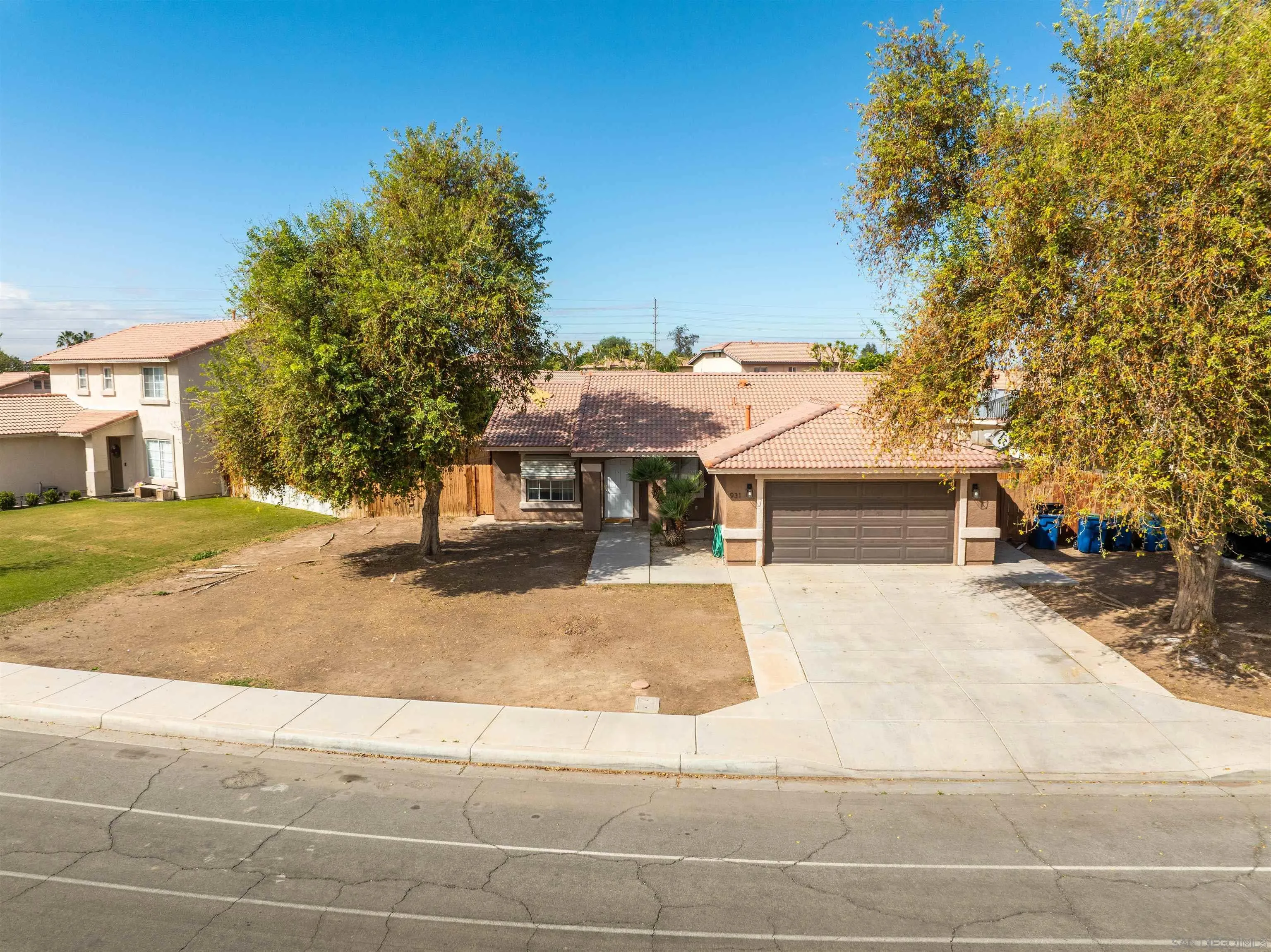 931 Jones Street Brawley, CA 92227 - Photo 2 of 17 a front view of a house with a yard and garage