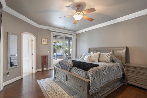 a bedroom with a large bed and a chandelier
