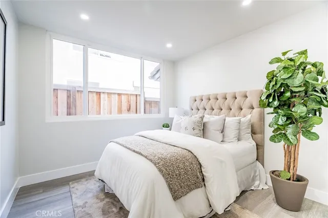 a bedroom with bed and a potted plant