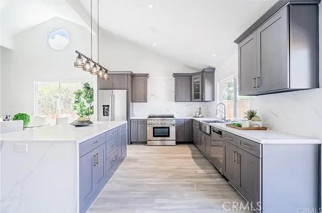 a kitchen with stainless steel appliances a sink and a counter top space