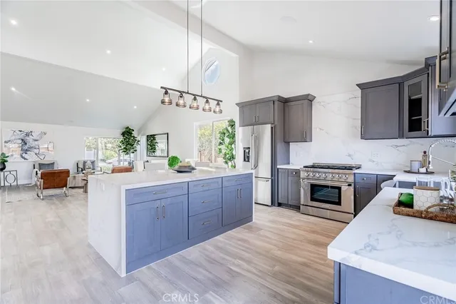 a kitchen with stainless steel appliances a stove sink and cabinets