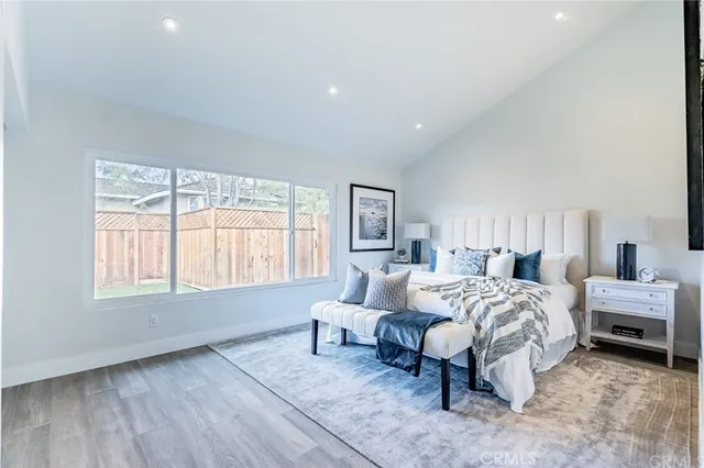 a bedroom with a bed and a large window