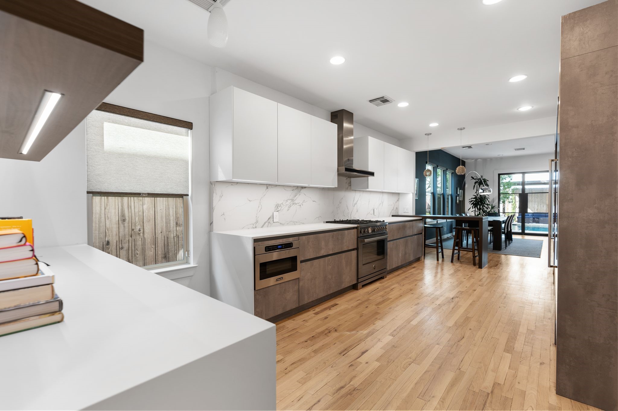 925 Waverly Street, Unit B Houston, TX 77008 - Photo 20 of 36 Dekton counters and quartz backsplashes flow to a convenient dining counter topped by handsome orb pendants. A separate dry bar with a wine refrigerator is perfect for a coffee/cocktail area.