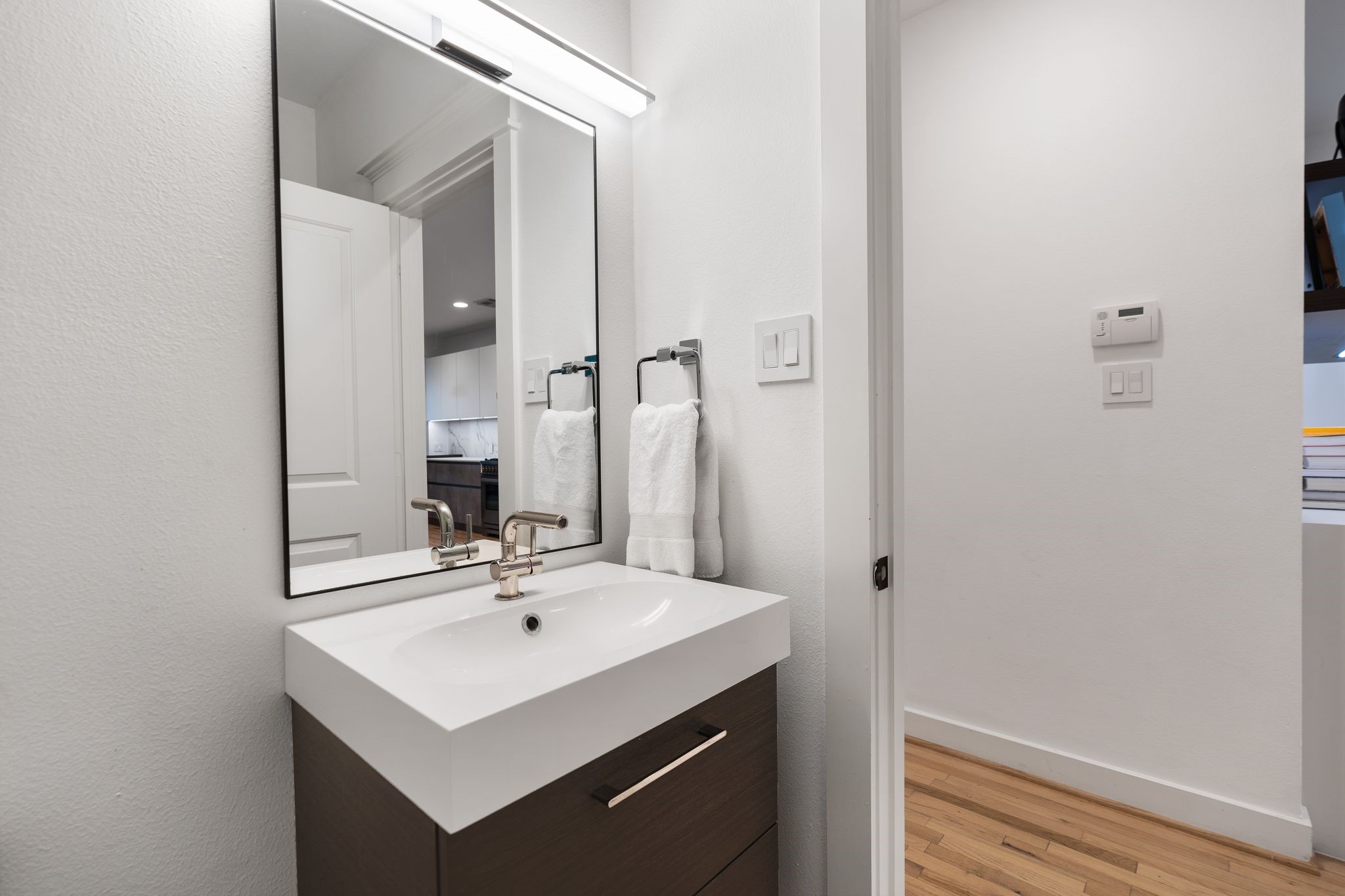 925 Waverly Street, Unit B Houston, TX 77008 - Photo 21 of 36 Located near the garage entry, the fully renovated powder room includes a modern vanity, contemporary fixtures, storage and handsome tilework.