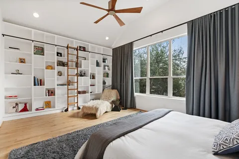 a bed sitting in a bedroom next to a window