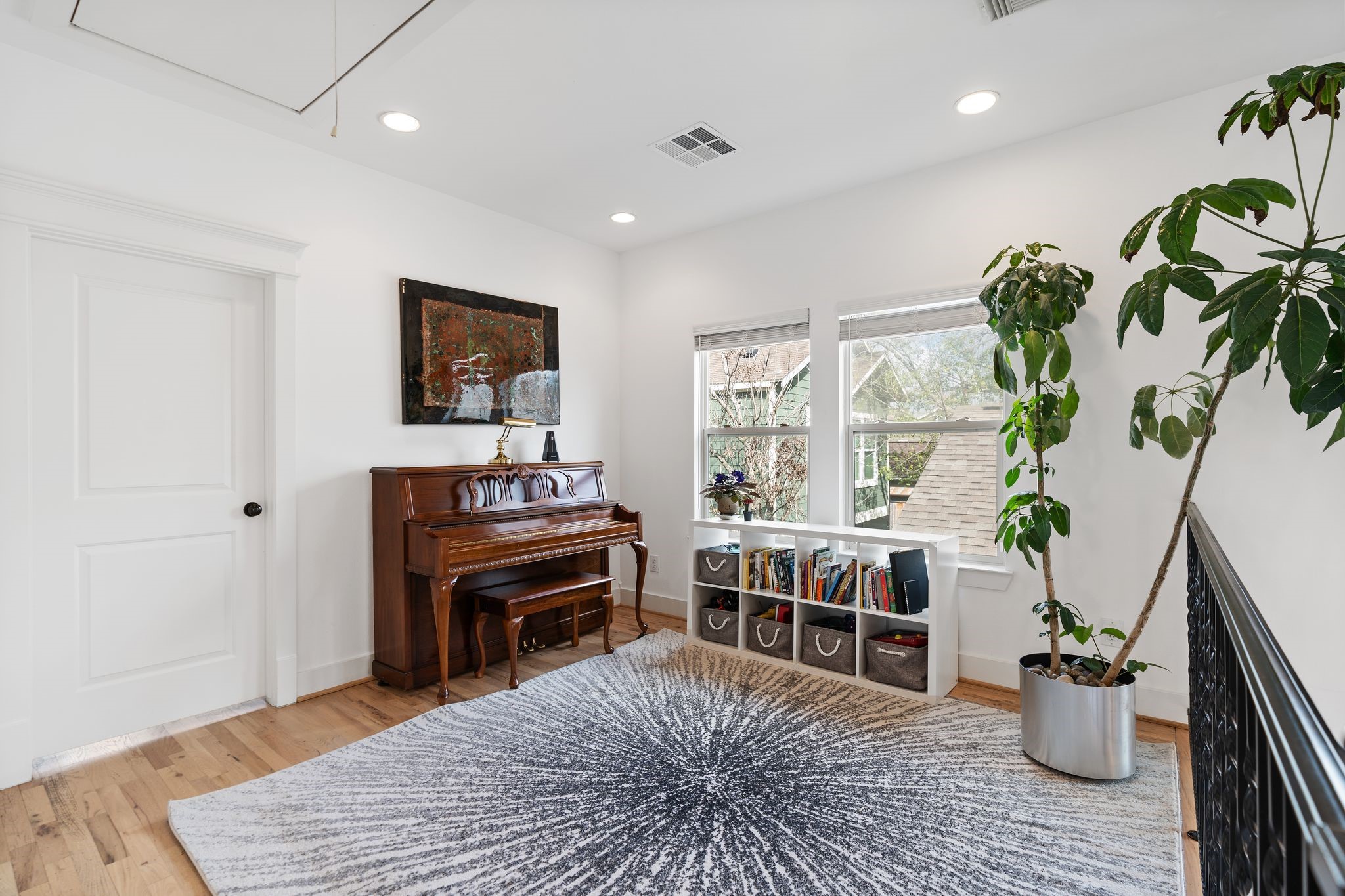925 Waverly Street, Unit B Houston, TX 77008 - Photo 30 of 36 The windowed upstairs landing is perfect as a reading nook, home office, playroom or all of the above. Above, you’ll find access to attic storage.