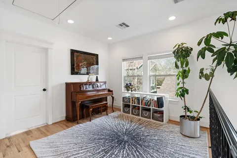 a spacious bedroom with a bed and a large window