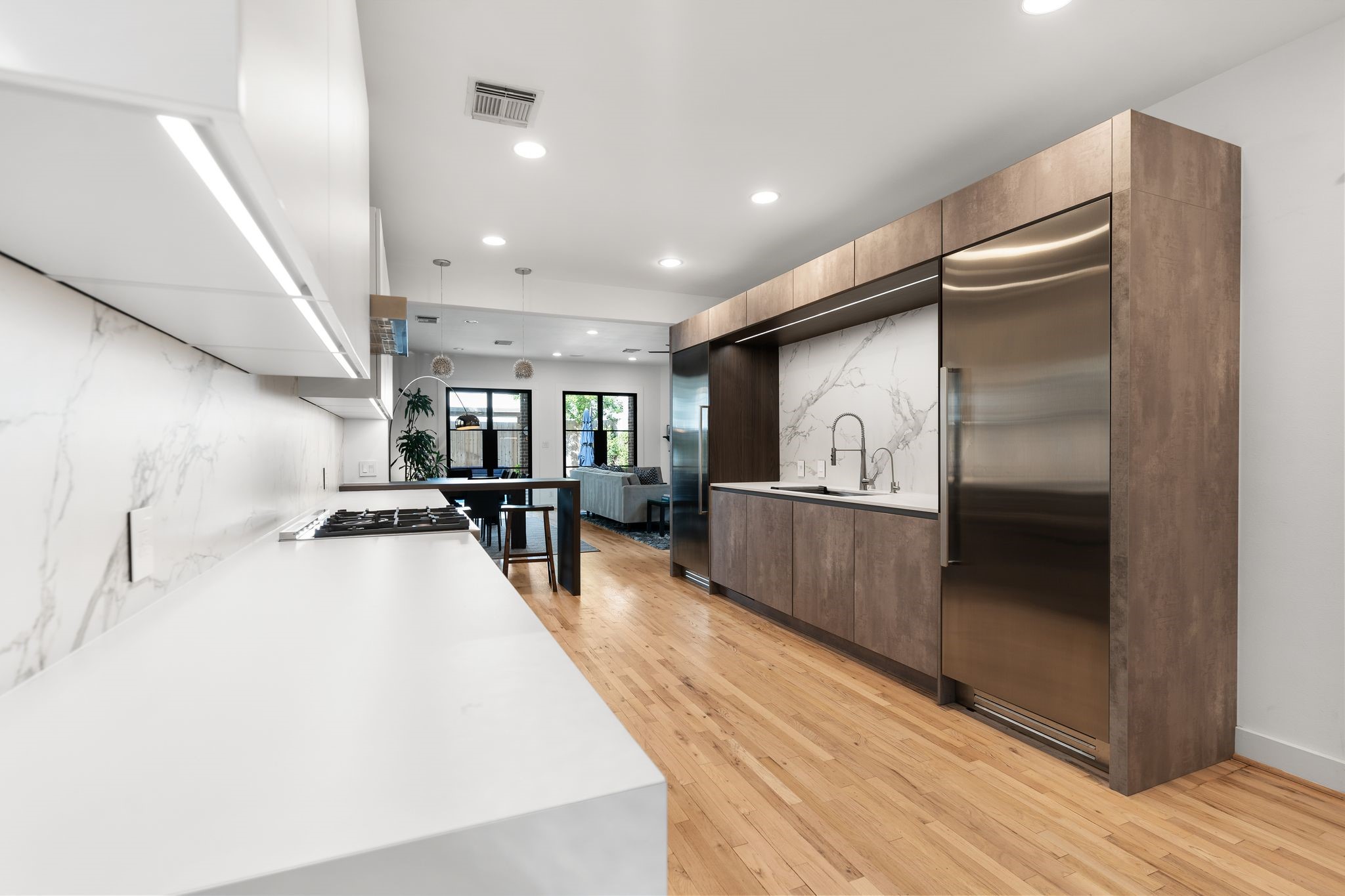 925 Waverly Street, Unit B Houston, TX 77008 - Photo 3 of 36 Chefs and designers alike will love the beautifully renovated gourmet kitchen featuring custom Leicht cabinetry, Dekton countertops and upscale appliances by Bertazzoni and Viking.