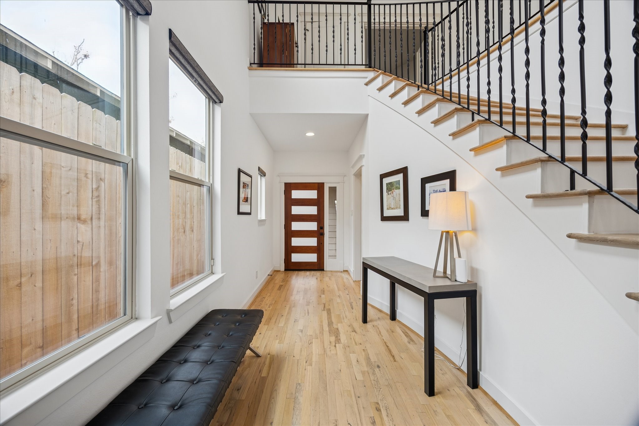 925 Waverly Street, Unit B Houston, TX 77008 - Photo 7 of 36 Lined with windows, the gracious double-height entry way provides ample space for a convenient bench and console table. Recently sanded and bleached floors run throughout.