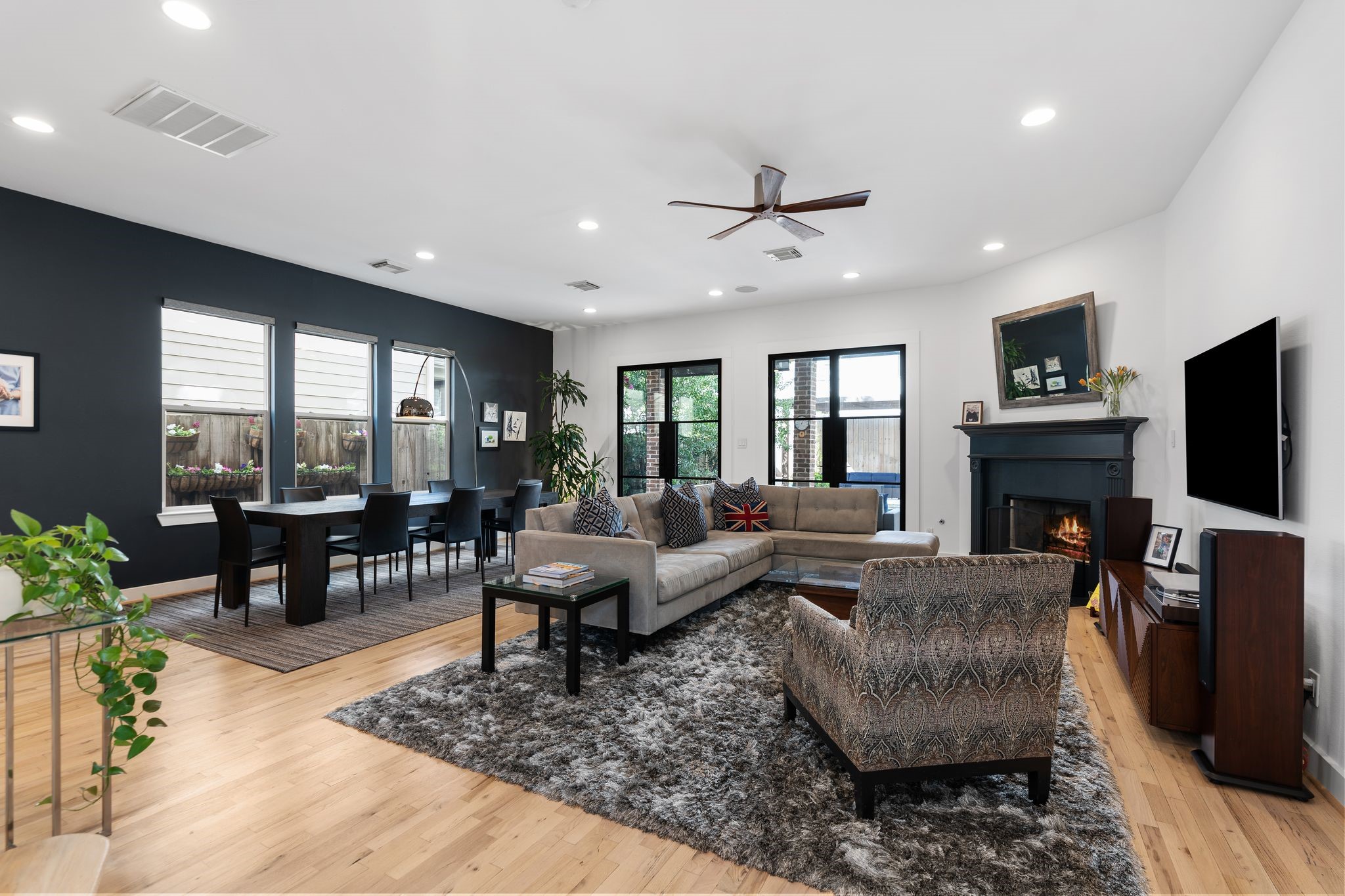 925 Waverly Street, Unit B Houston, TX 77008 - Photo 8 of 36 Relax and entertain in this inviting living/dining room anchored by a fireplace and custom iron-and-glass French doors.