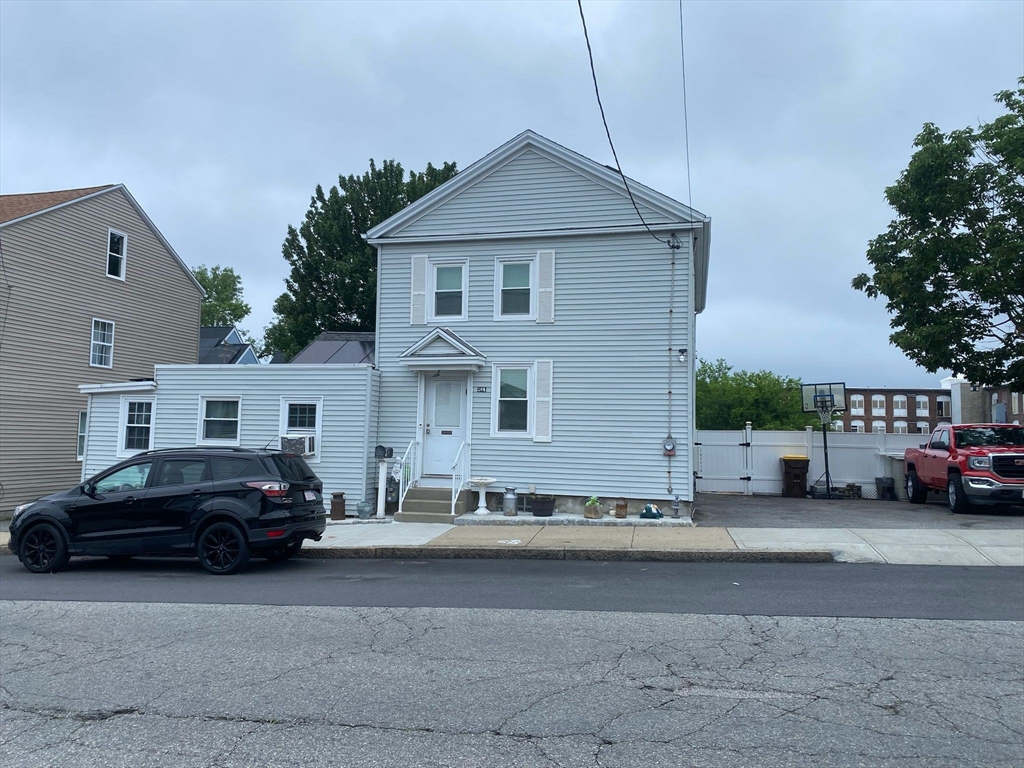 368 Globe Street Fall River, MA 02724 - Photo 2 of 31 a front view of a house with cars parked on road