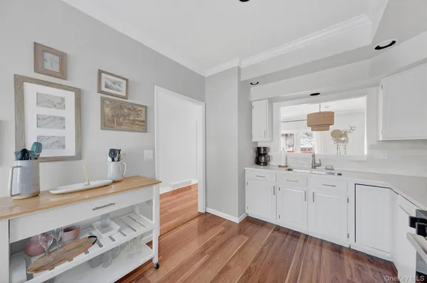 a view of kitchen with furniture wooden floor and window