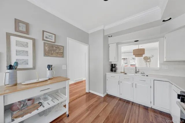 a view of kitchen with furniture wooden floor and window