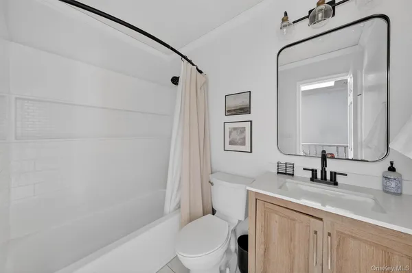 a bed sitting in a spacious bedroom next to a window