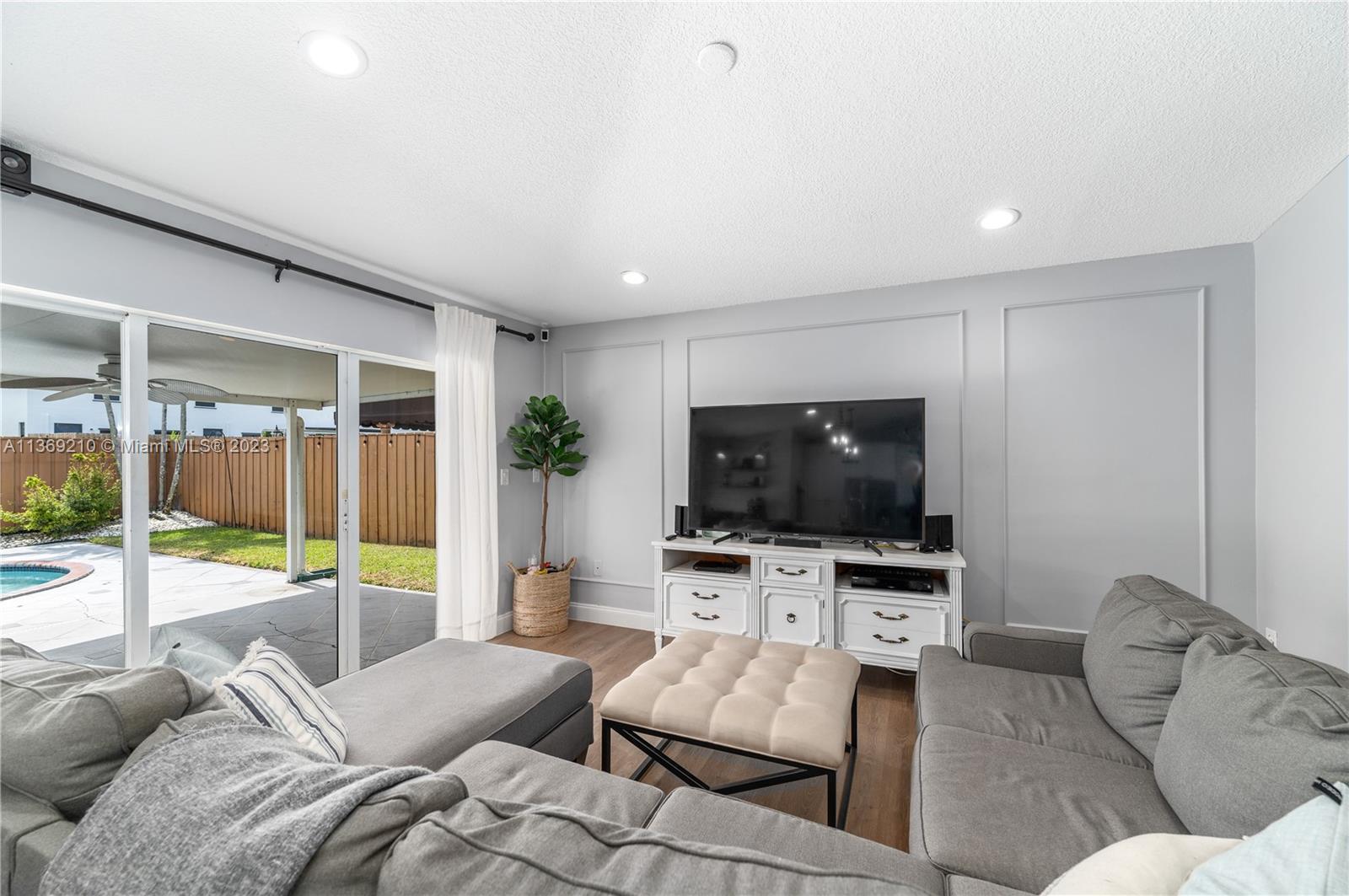 18217 Southwest 148th Ave Road Miami, FL 33187 - Photo 14 of 29 a living room with furniture and a flat screen tv