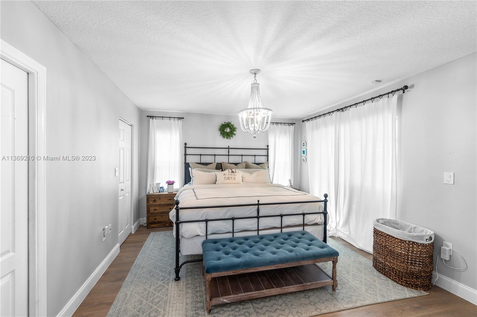 18217 Southwest 148th Ave Road Miami, FL 33187 - Photo 16 of 29 a bedroom with a bed and a dresser in it