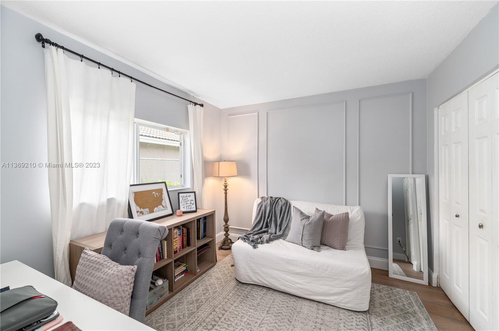 18217 Southwest 148th Ave Road Miami, FL 33187 - Photo 20 of 29 a living room with furniture and a closet