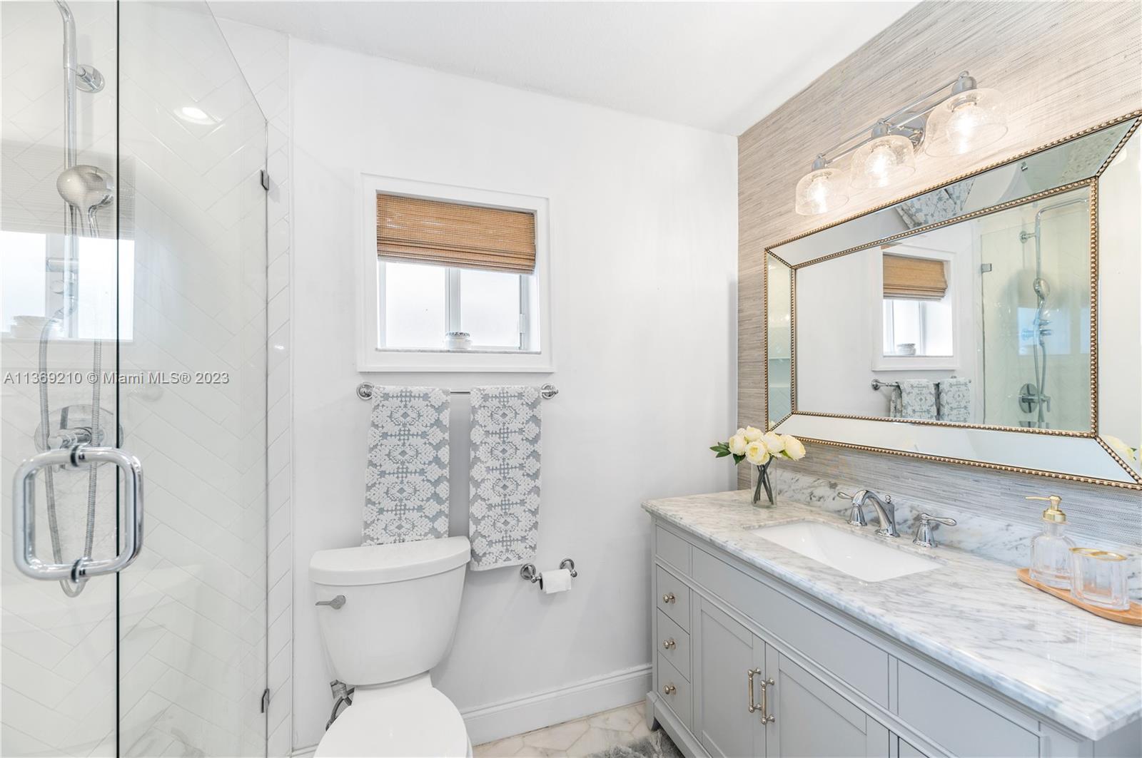 18217 Southwest 148th Ave Road Miami, FL 33187 - Photo 21 of 29 a bathroom with a granite countertop sink toilet and shower