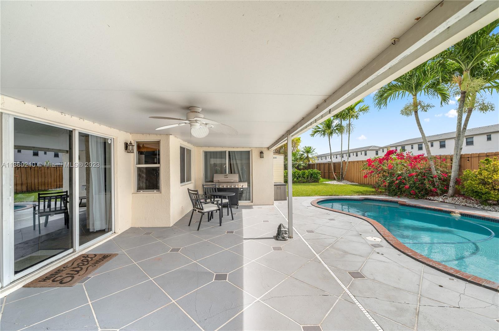 18217 Southwest 148th Ave Road Miami, FL 33187 - Photo 25 of 29 a view of a porch with furniture and garden