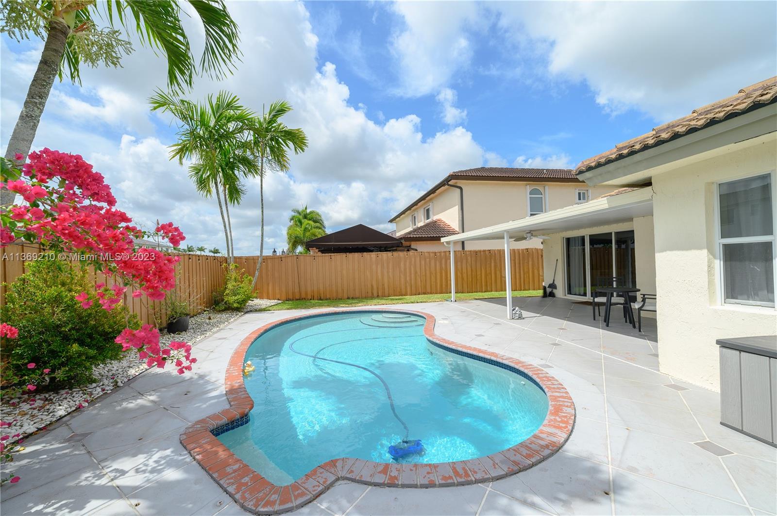 18217 Southwest 148th Ave Road Miami, FL 33187 - Photo 28 of 29 a view of a house with a backyard