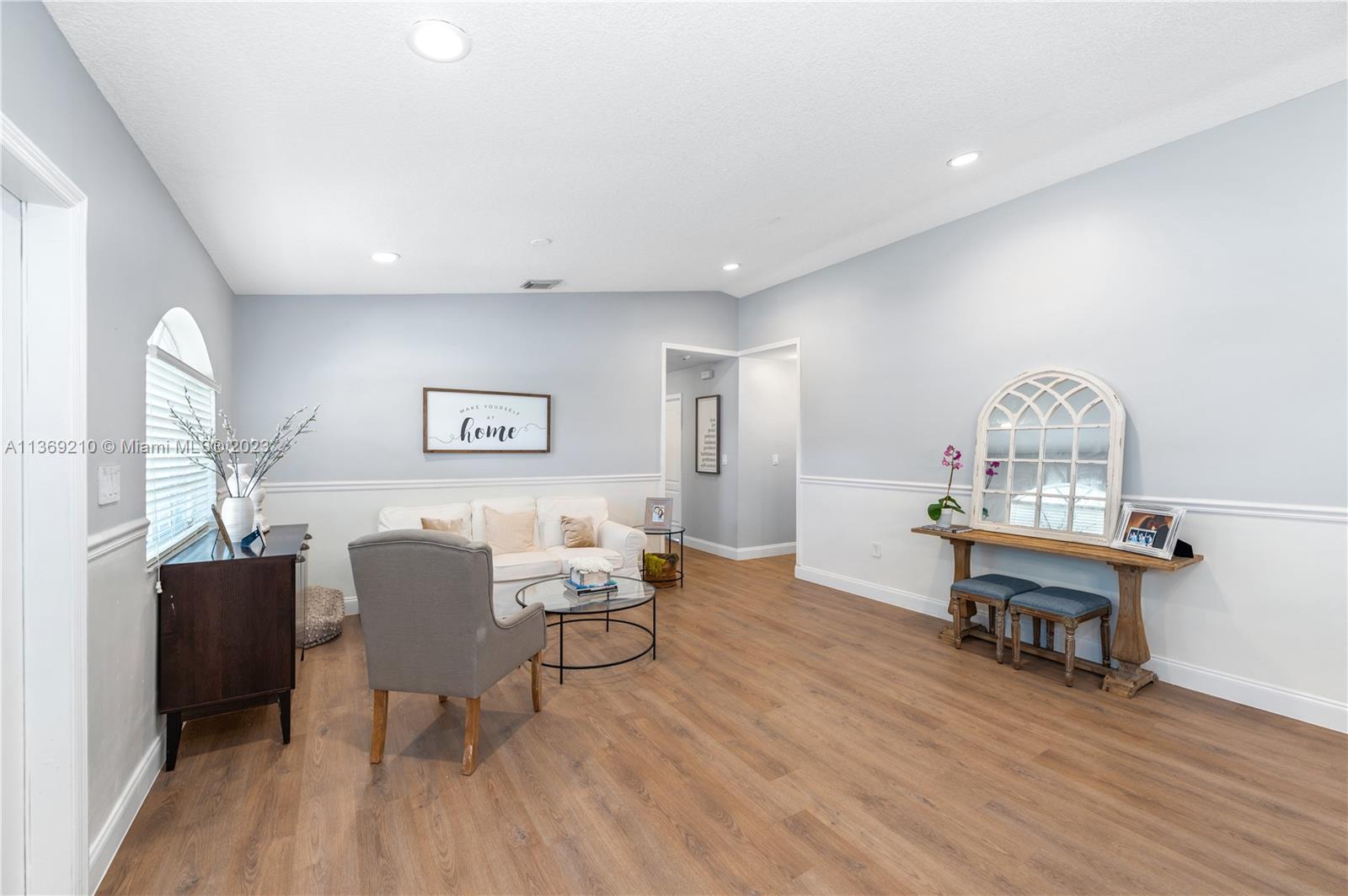 18217 Southwest 148th Ave Road Miami, FL 33187 - Photo 4 of 29 a living room with furniture and a wooden floor