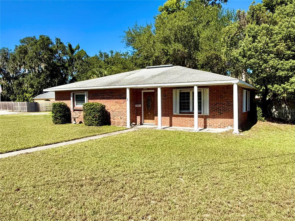 a front view of a house with a garden