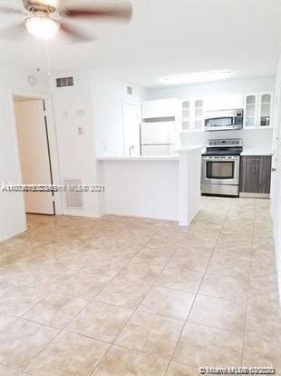4581 West McNab Road, Unit 14 Pompano Beach, FL 33069 - Photo 6 of 10 a view of kitchen with cabinets