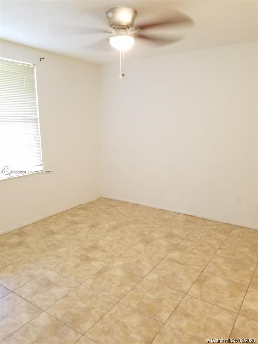 4581 West McNab Road, Unit 14 Pompano Beach, FL 33069 - Photo 8 of 10 an empty room with a fan & a window