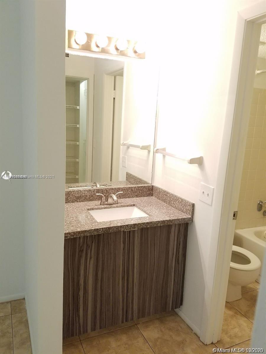 4581 West McNab Road, Unit 14 Pompano Beach, FL 33069 - Photo 9 of 10 a bathroom with a sink and a mirror