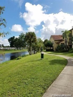 4581 West McNab Road, Unit 14 Pompano Beach, FL 33069 - Photo 10 of 10 a view of a fountain in front of the house