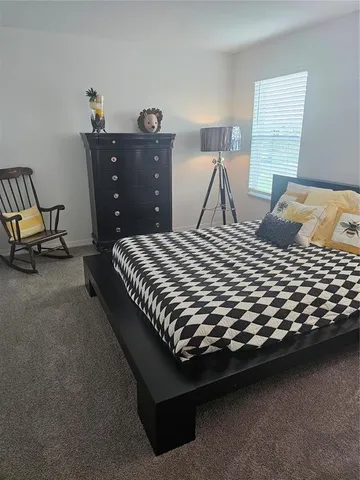 a bedroom with a bed and dresser