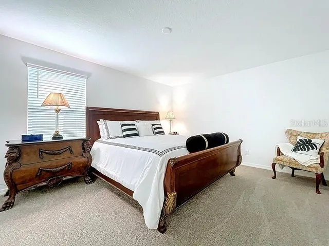 a bedroom with a bed and a couch