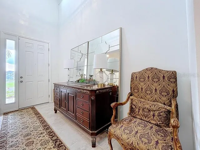 a spacious bedroom with a bed and wooden floor