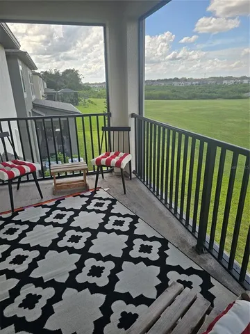 a view of balcony with floor to ceiling windows with wooden floor