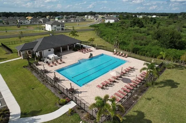 a view of a swimming pool with a yard