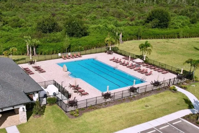 a view of a swimming pool with a yard