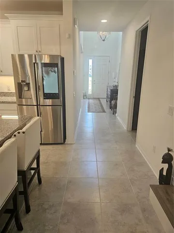 a view of a refrigerator in kitchen and a kitchen