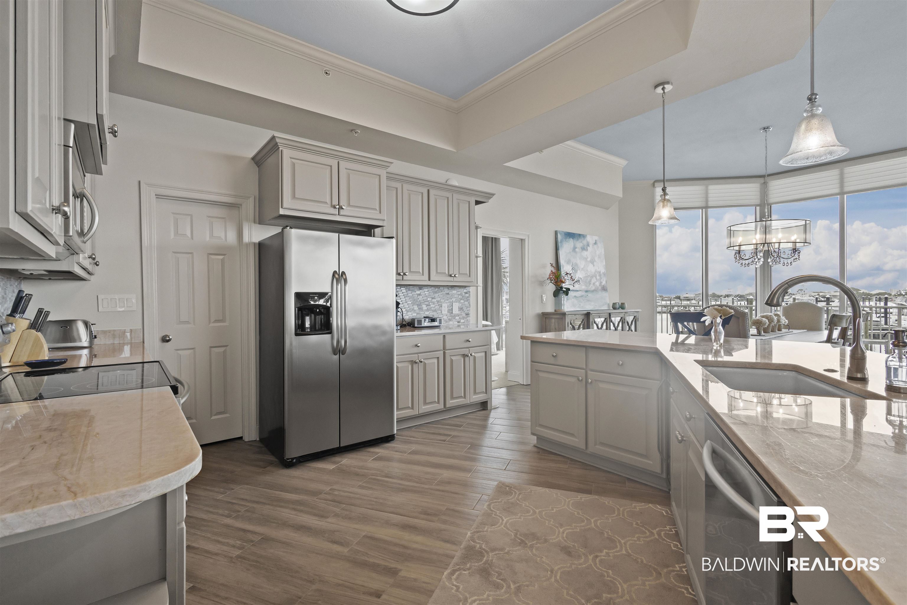 27800 Canal Road, Unit 120 Orange Beach, AL 36561 - Photo 9 of 68 Kitchen featuring sink, decorative light fixtures, appliances with stainless steel finishes, tasteful backsplash, and a notable chandelier