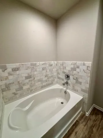 a bathroom with a granite countertop sink a mirror and vanity