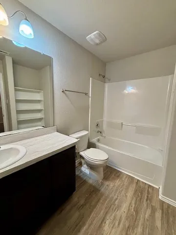 a bathroom with a sink toilet and a mirror