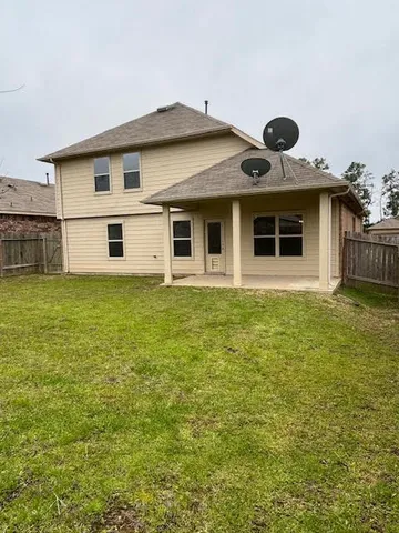 a view of a big room with a big yard and large tree