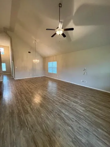 a view of a room with wooden floor and fan