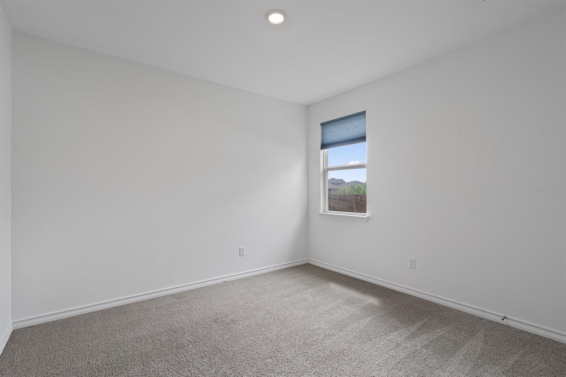 104 Stinchcomb Road Hutto, TX 78634 - Photo 24 of 40 Bedroom 3 is also located at the front of the home and features a walk-in closet, making it a comfortable and functional secondary bedroom. It sits near the full bathroom shared with Bedroom 2.