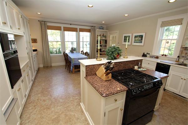 1 Channing Road Dedham, MA 02026 - Photo 12 of 22 a kitchen with stainless steel appliances granite countertop a stove top oven a sink dishwasher a dining table and chairs with wooden floor