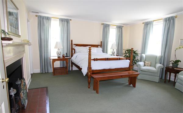 1 Channing Road Dedham, MA 02026 - Photo 17 of 22 a bedroom with a bed and a fireplace