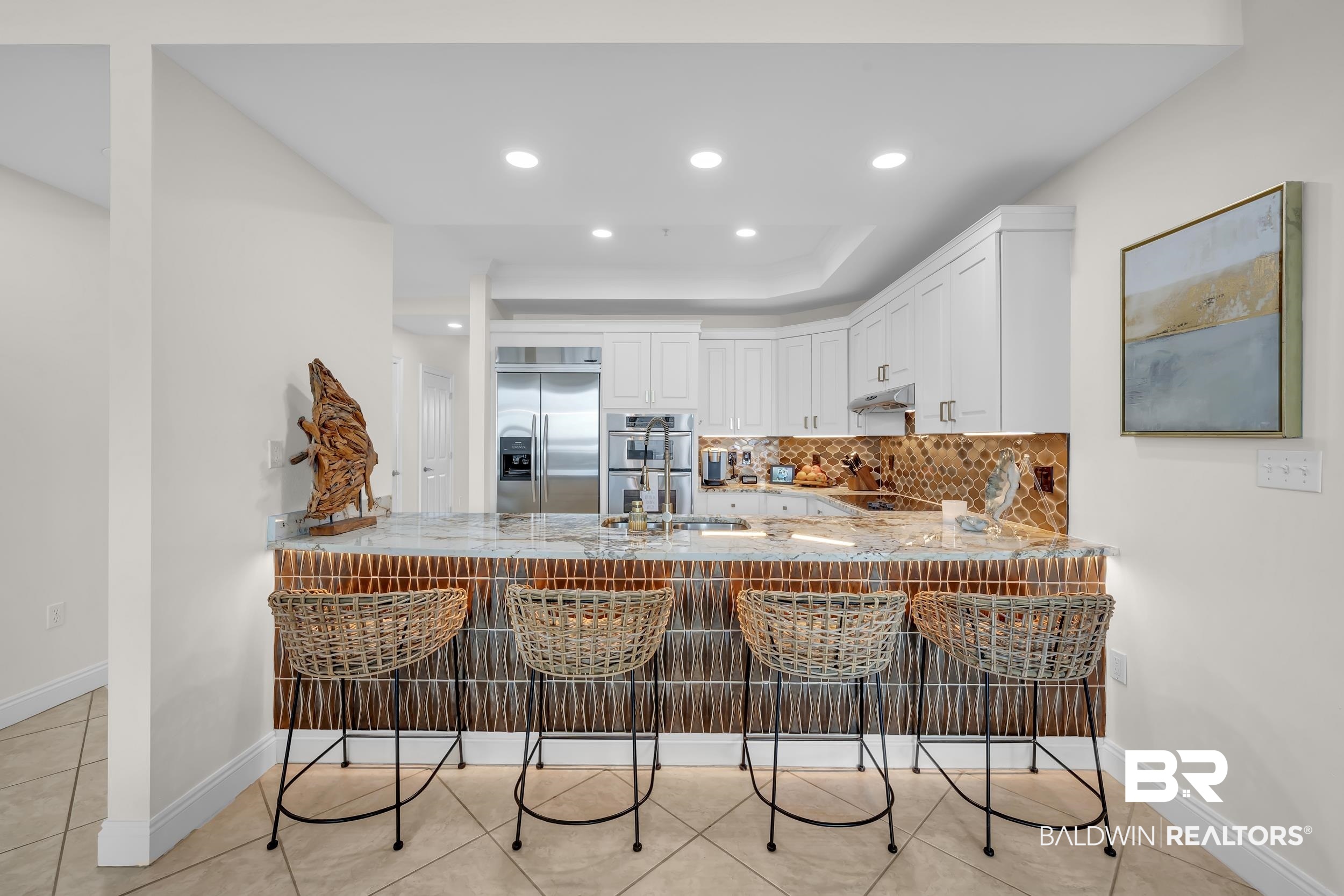 28250 Canal Road, Unit 307 Orange Beach, AL 36561 - Photo 20 of 56 Kitchen with a kitchen breakfast bar, a peninsula, backsplash, stainless steel appliances, and recessed lighting